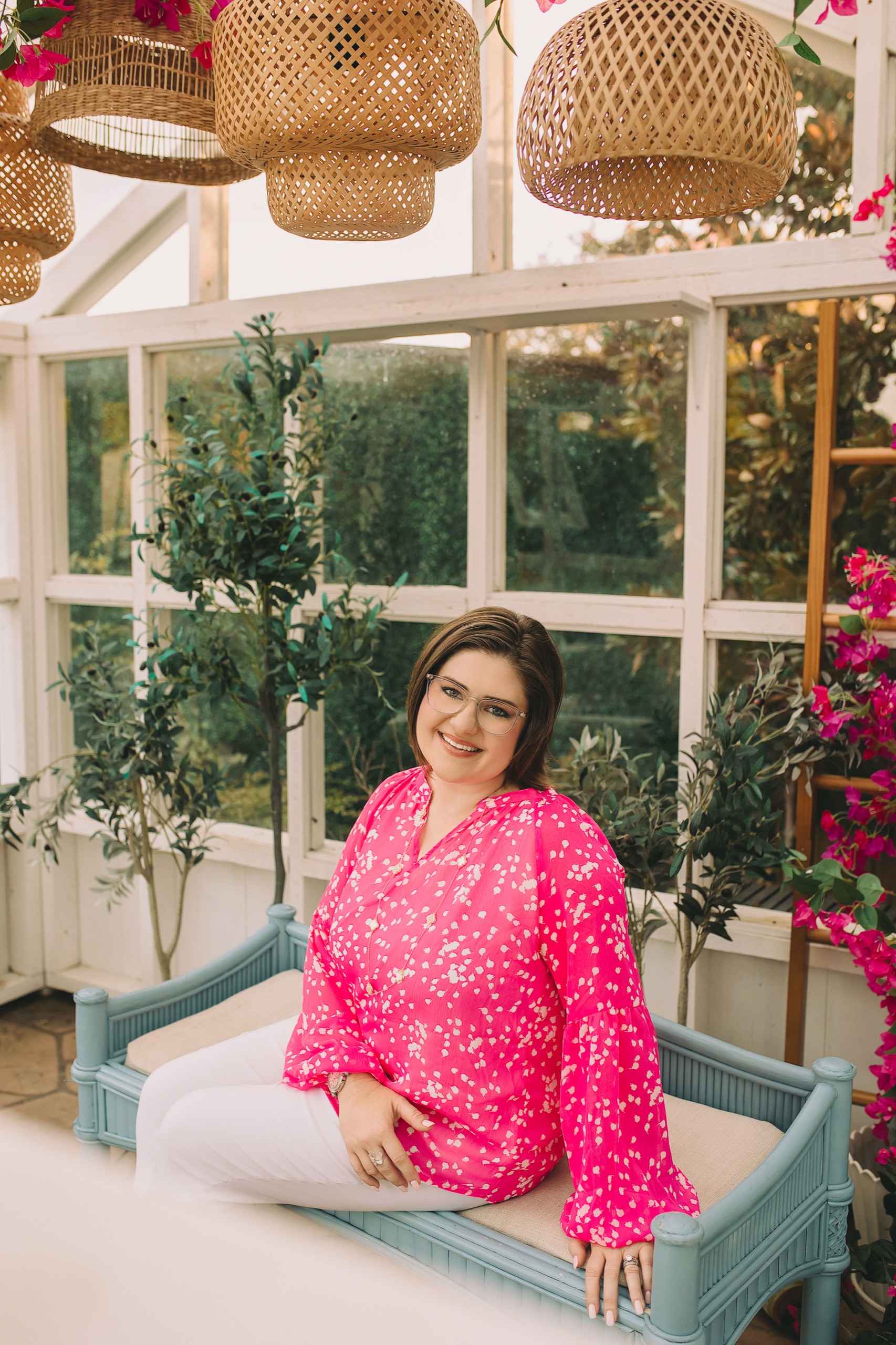 Personal-branding portrait in a sunlit greenhouse with rattan lanterns