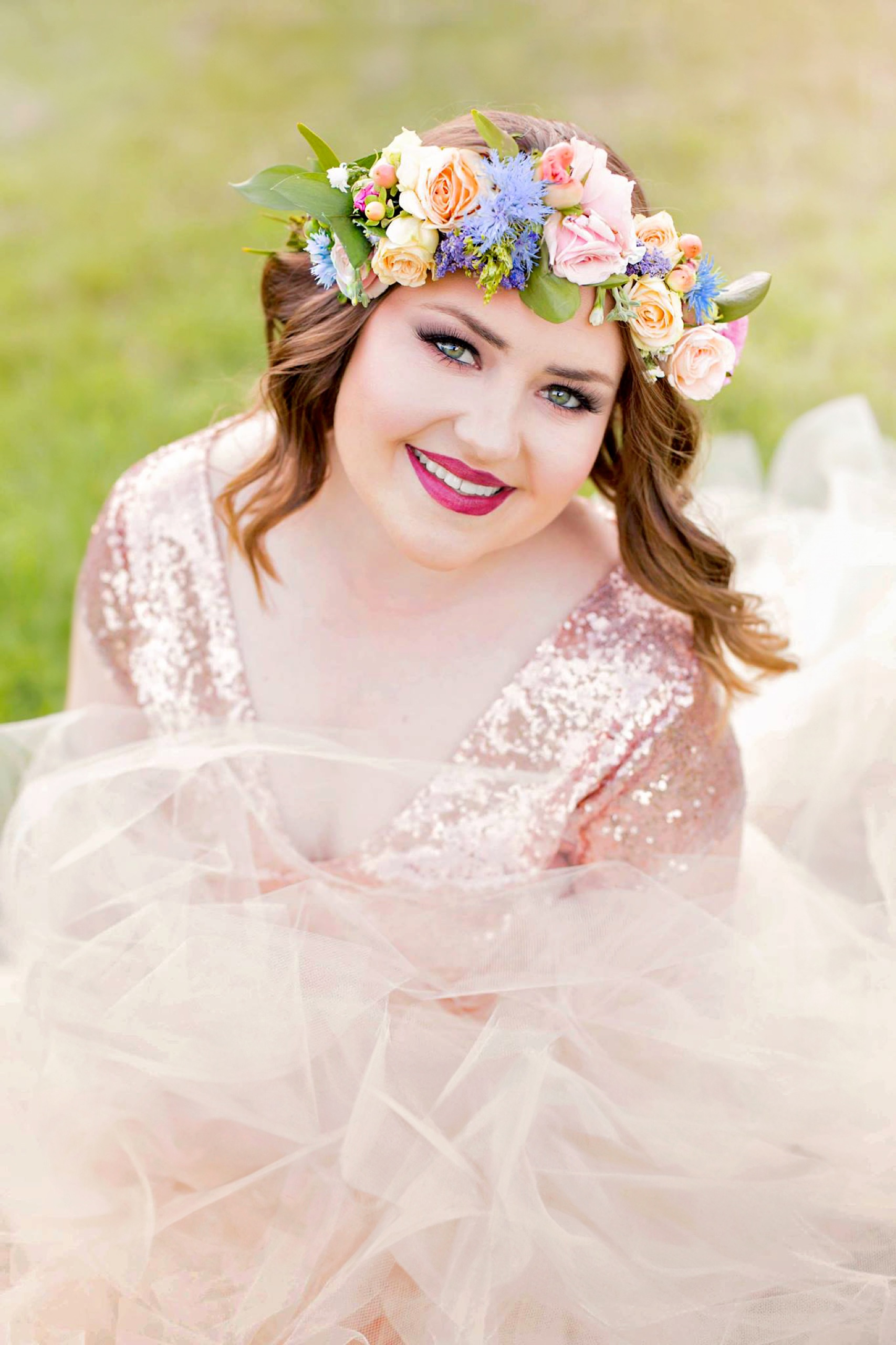 Portrait in a fresh flower crown and blush tulle gown at golden hour